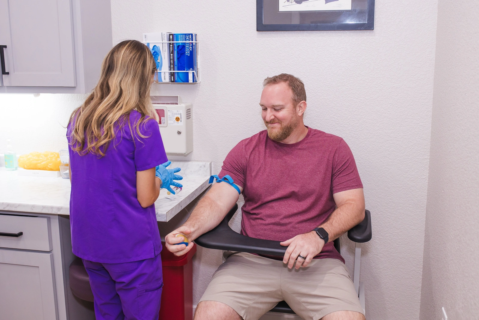 A patient seated with a JM Wellness staff member preparing for lab work